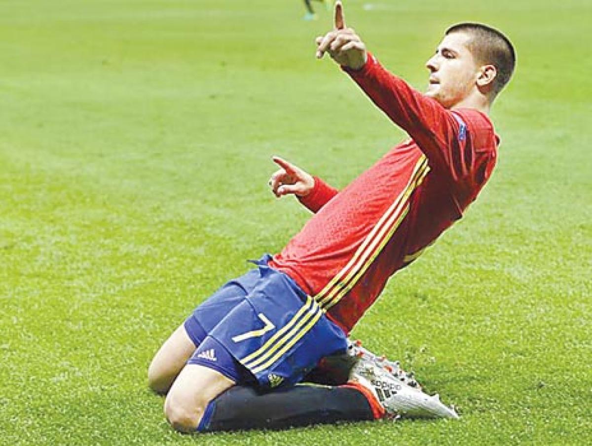 Morata brace guides Spain into last 16
