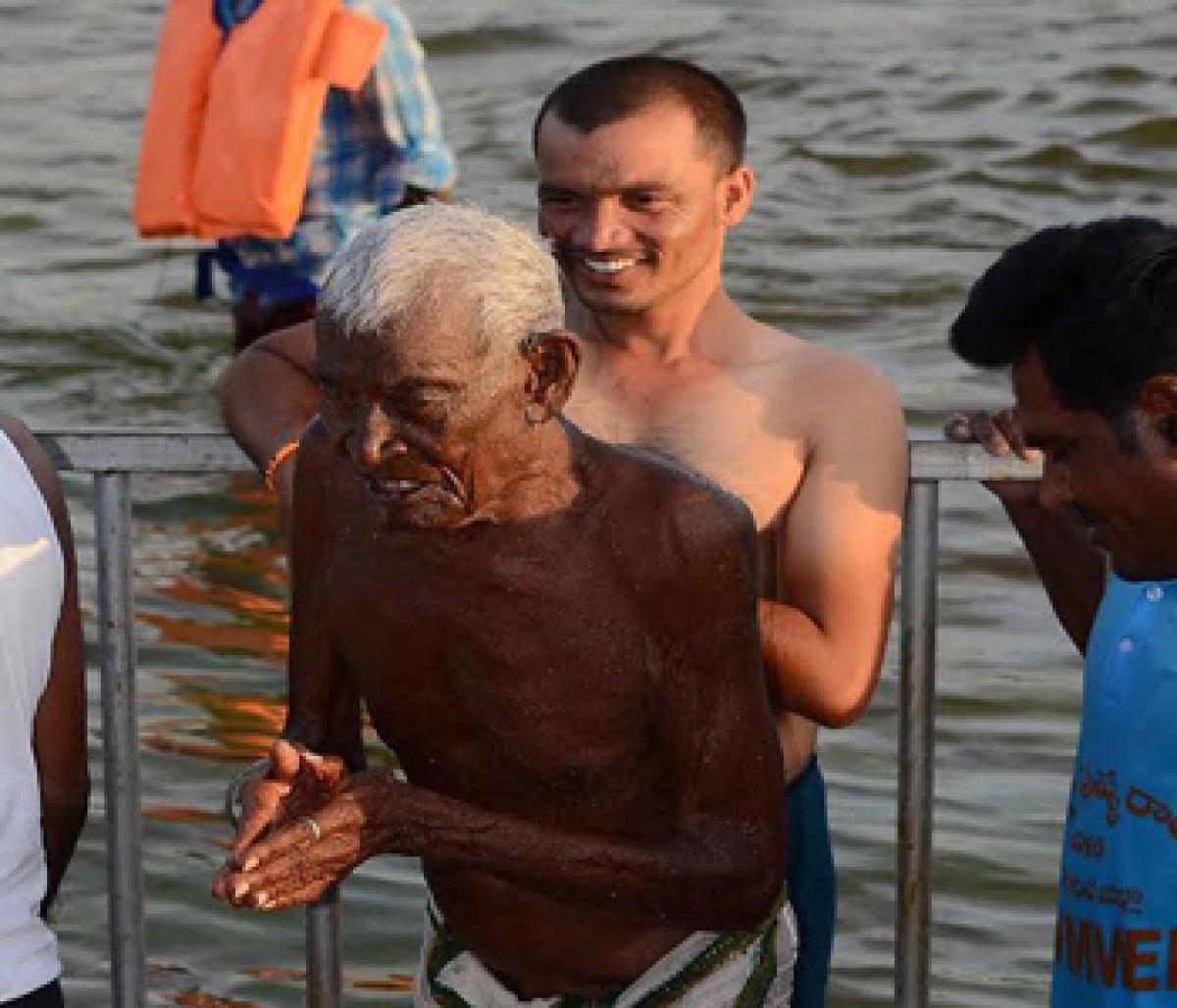 110-year-old devotee takes holy dip.