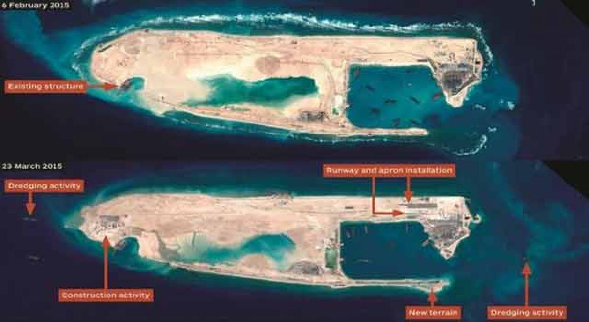 China lands first military plane on disputed reef