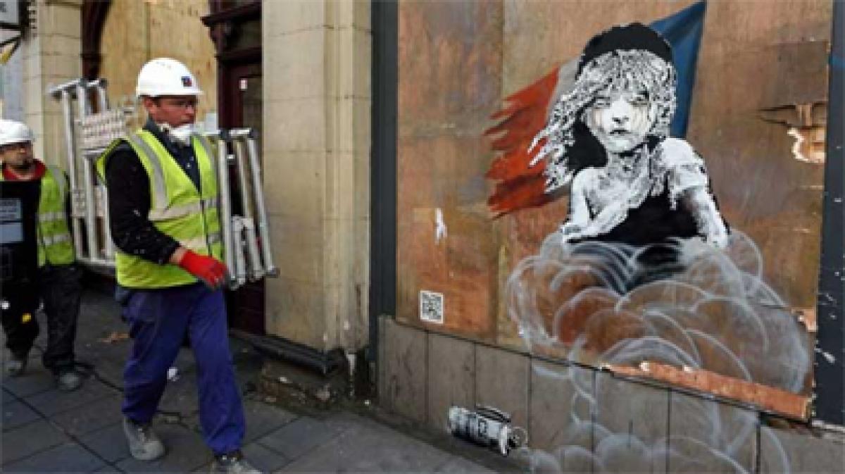 London builders cover up Banksy mural against France