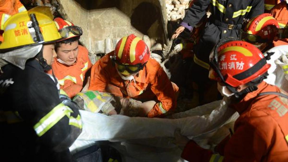 China building collapse: 3-year-old girl survives in the arms of dead parents