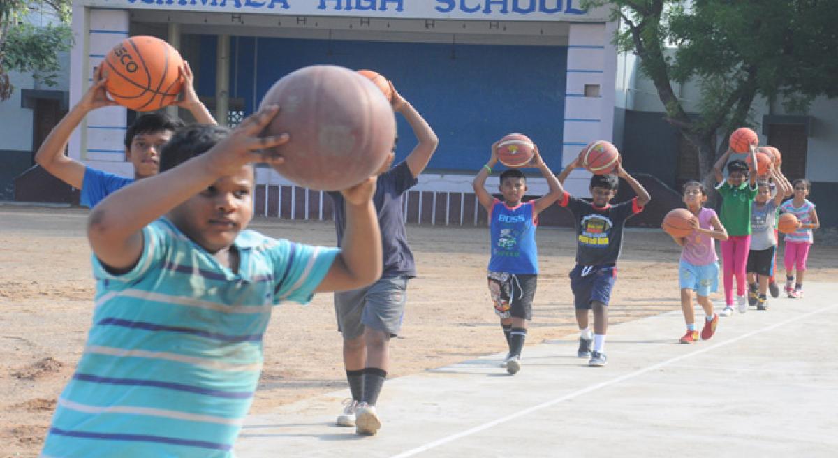 Children try their hands at baseball and basketball