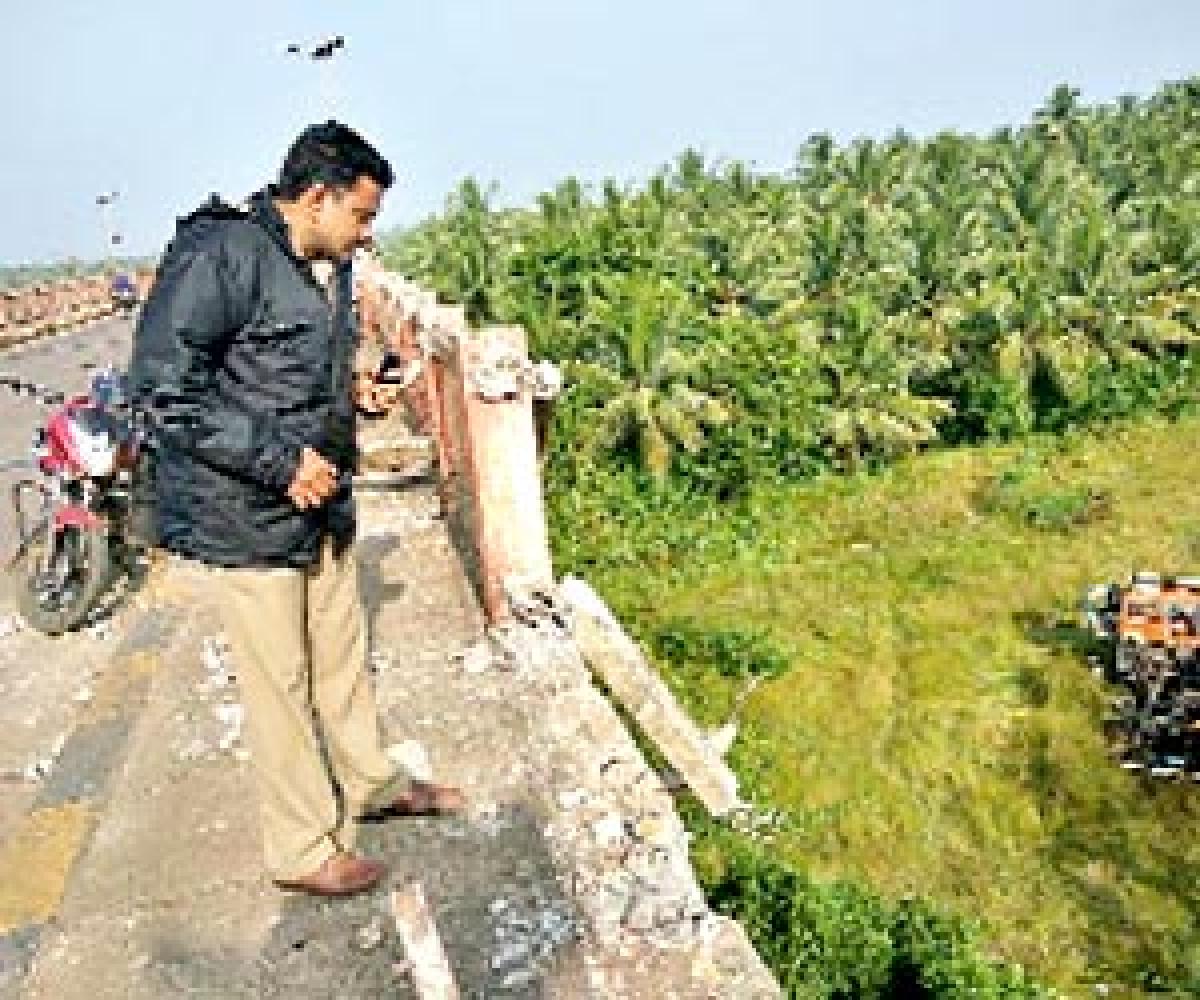 Two killed as container falls off bridge