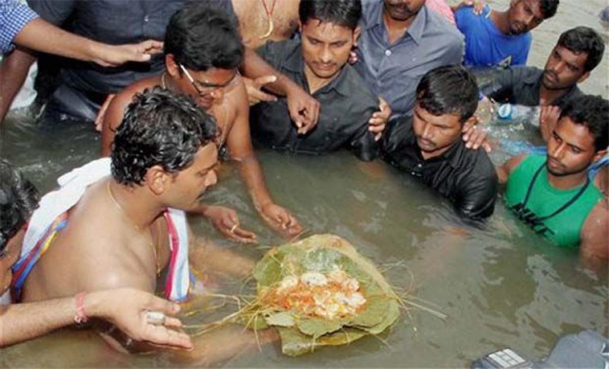 Jagan sparks controversy after holy dip with cross