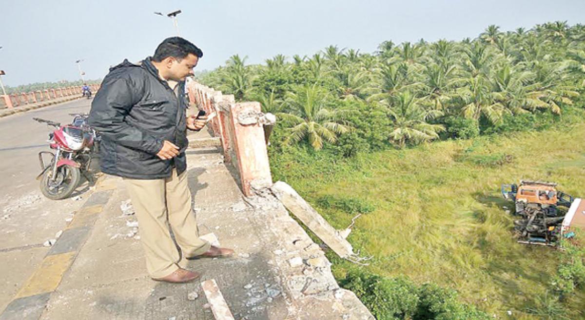 Two killed as container falls off bridge