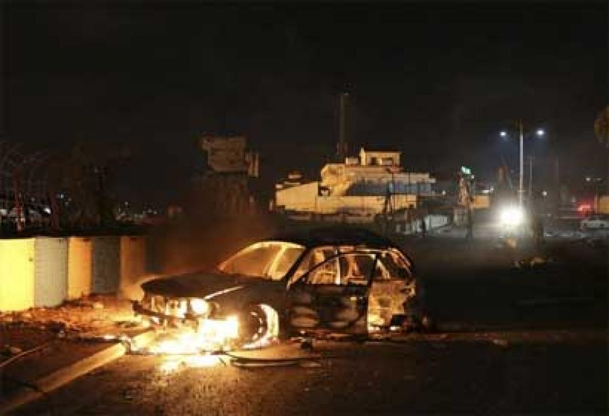 12 dead as twin blasts, gunfire rock Mogadishu hotel