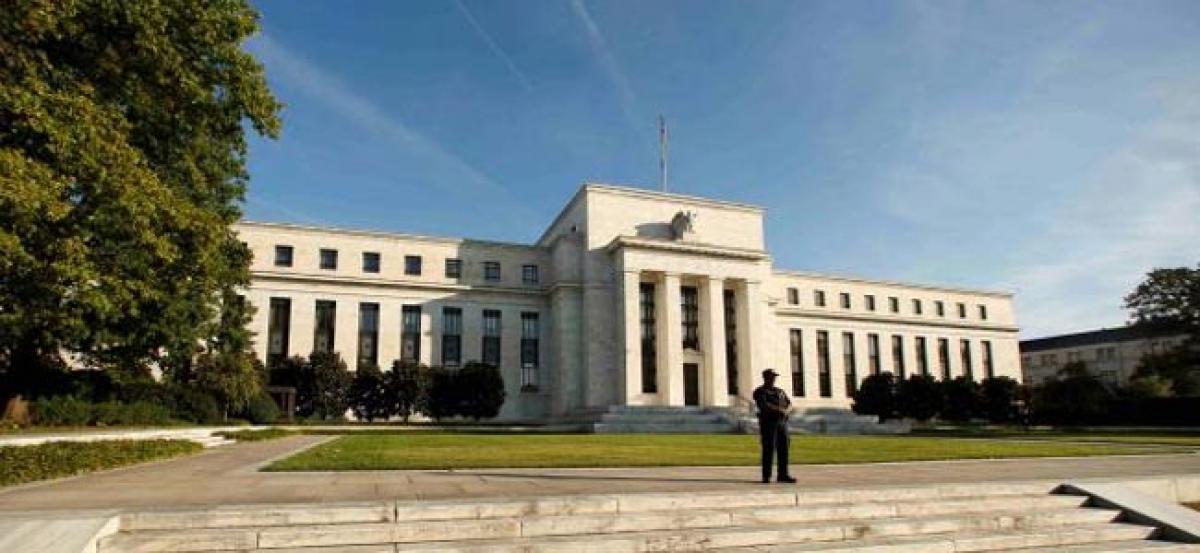 Fed holds rates steady, sets stage for December hike