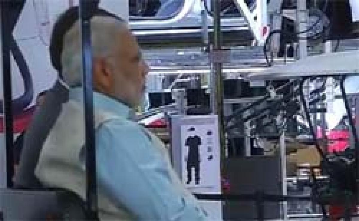 PM Modi Takes Ride in Electric Car Factory With Tesla Chief
