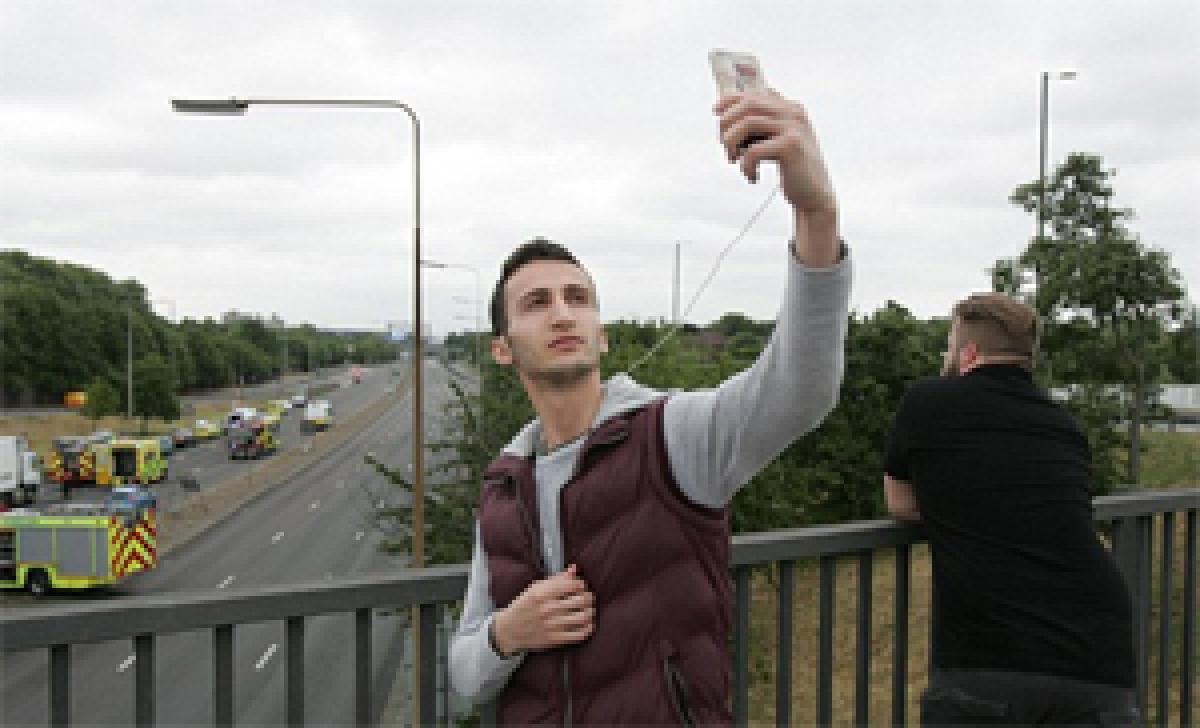 Onlooker takes selfie at road crash site