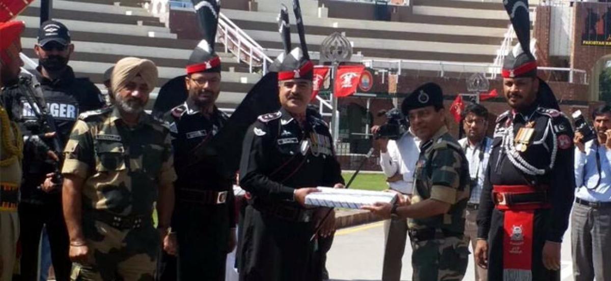 Pakistani Rangers offer sweets to BST at Attari Wagah Border on Pakistan National Day