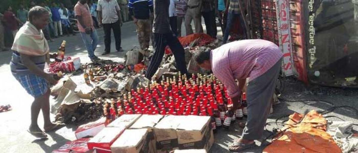 Beer goes down the drain as truck carrying bottles overturns