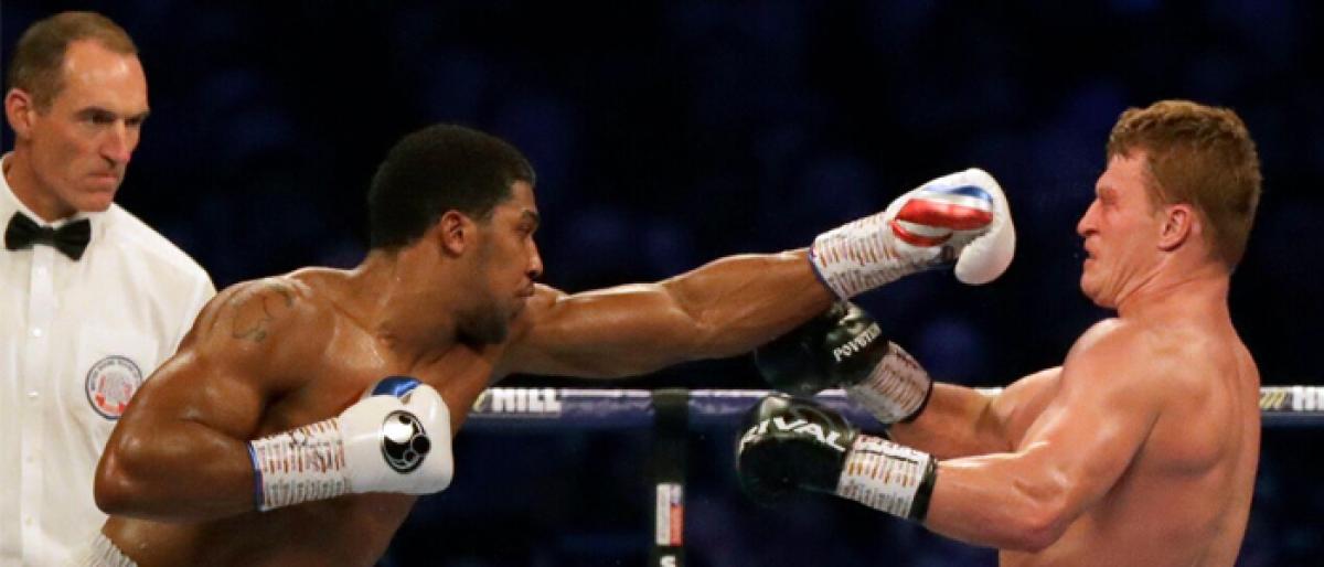 British boxer Anthony Joshua retains titles at Wembley Stadium in London