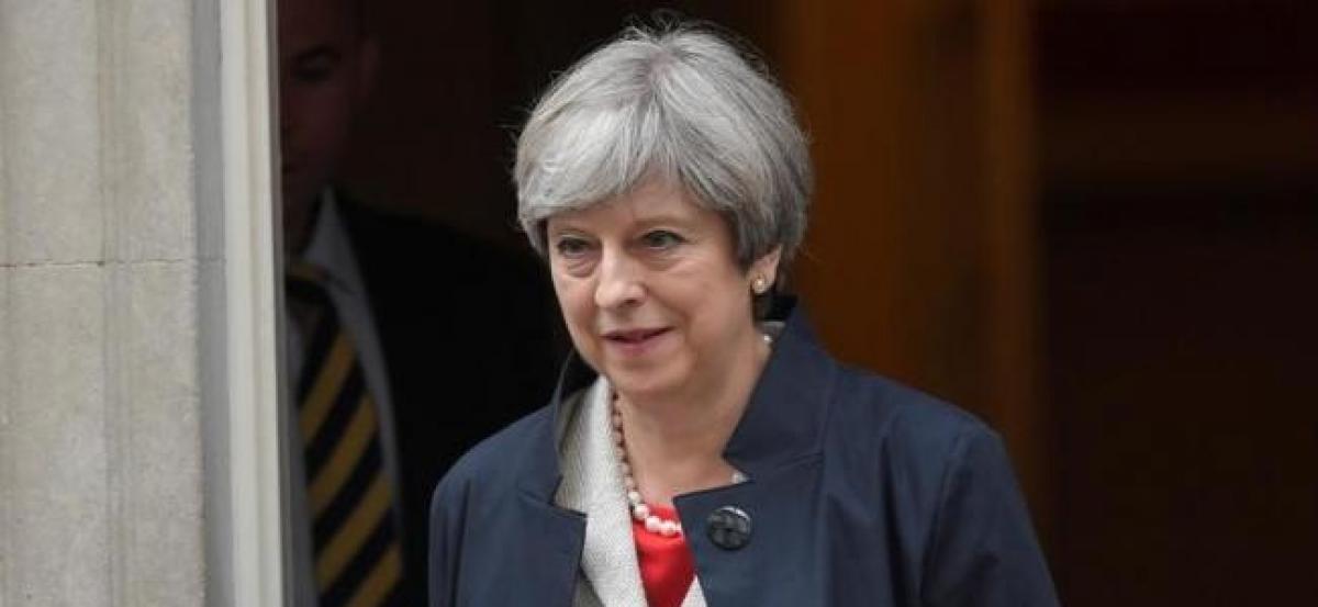 British PM May finds it lonely at the top, but battles on - for now