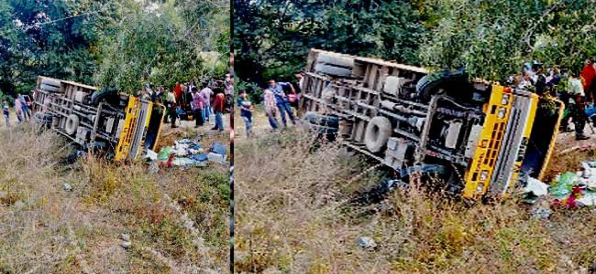 Close shave for 60 as bus falls on its side