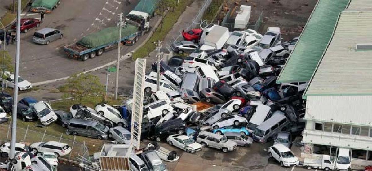 Typhoon kills at least 9 in Japan, boats move tourists from flooded airport