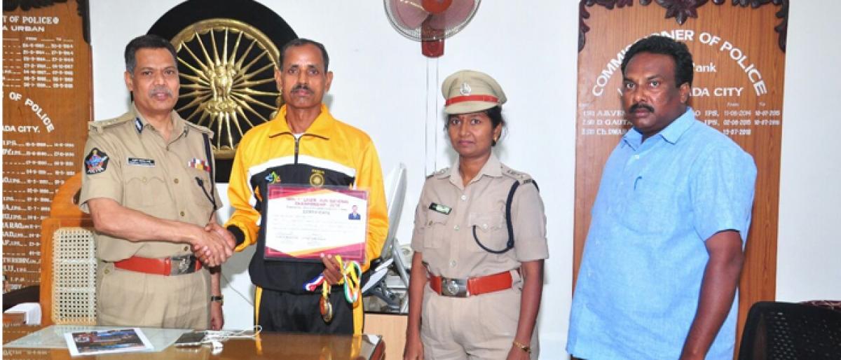 CP Ch Dwaraka Tirumala Rao greets Armed Reserve Head Constable G Srinivas Naik for winning gold medal at running event in Pune