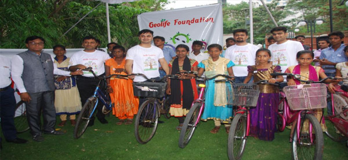 Geolife Agritech distributes cycles on 10th anniversary