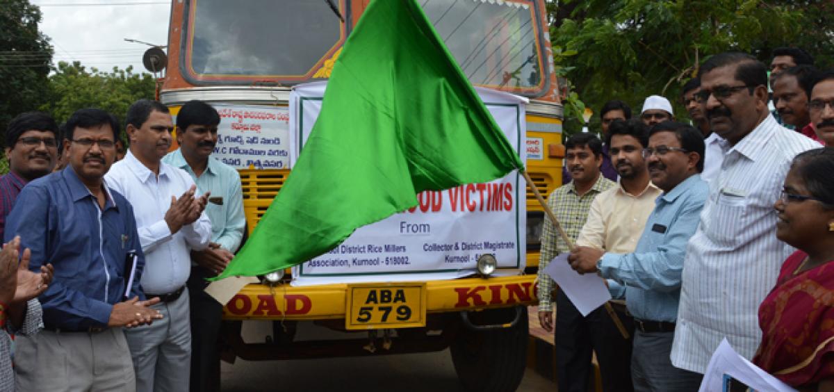 Collector flags off trucks with flood relief material