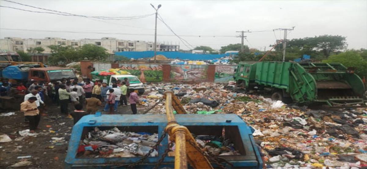 Workers, locals protest on piling of garbage