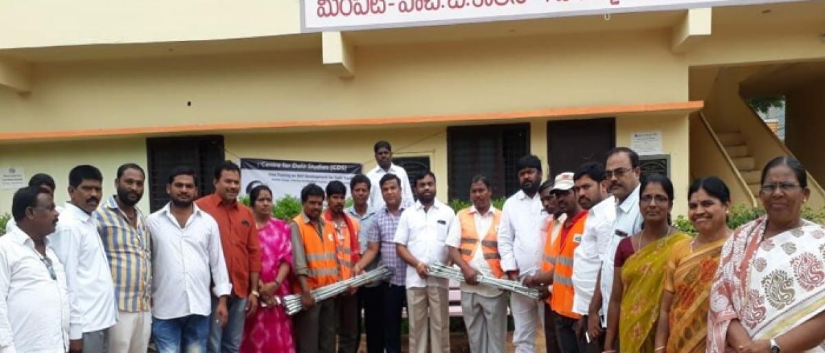 Corporator Golluri Anjaiah distributes drainage cleaning rods