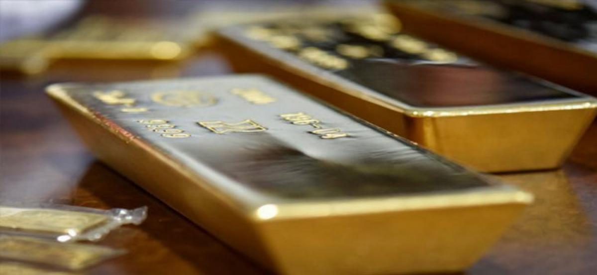 Gold slips on firmer dollar ahead of Jackson Hole meeting