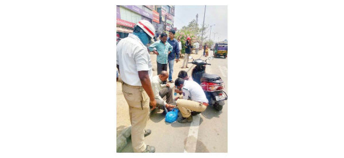 Official gives first aid to pedestrian