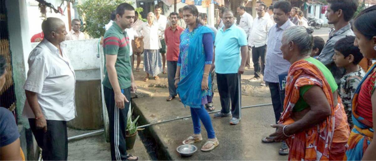 Civic chief Sumit Kumar interacts with people on sanitation in Rajahmundry