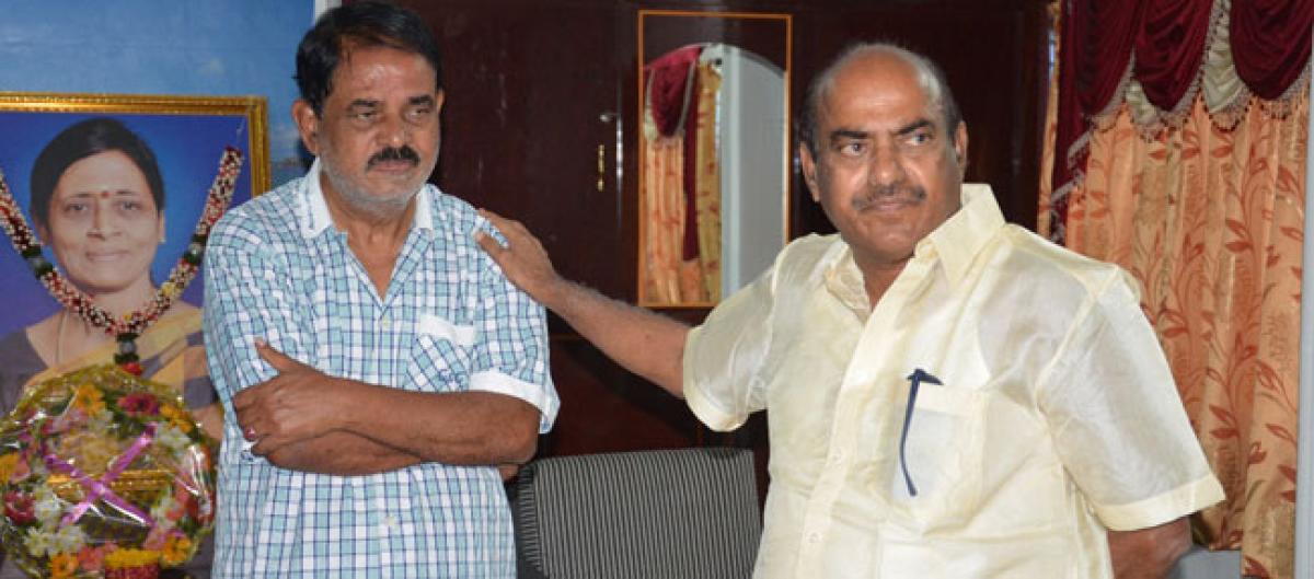 MP J C Diwakar Reddy, his son console Palle