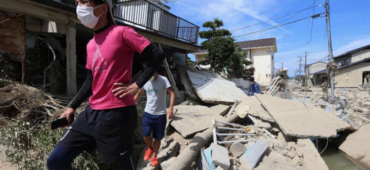 Rescuers race to find survivors after Japan floods kill at least 112