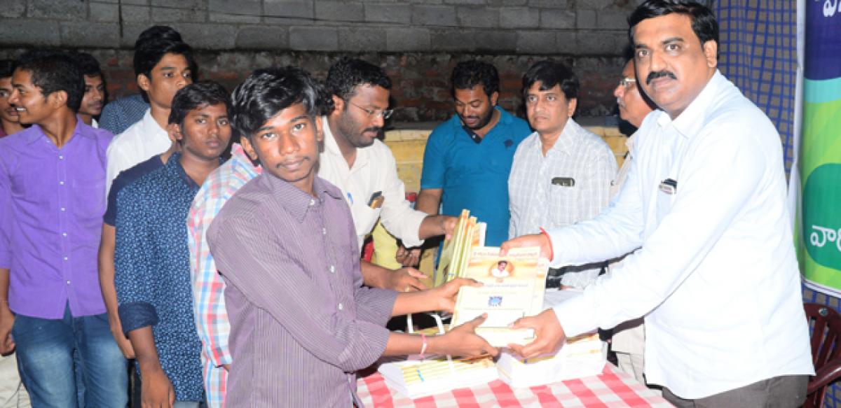Tulasi Dharmacharan distributes books