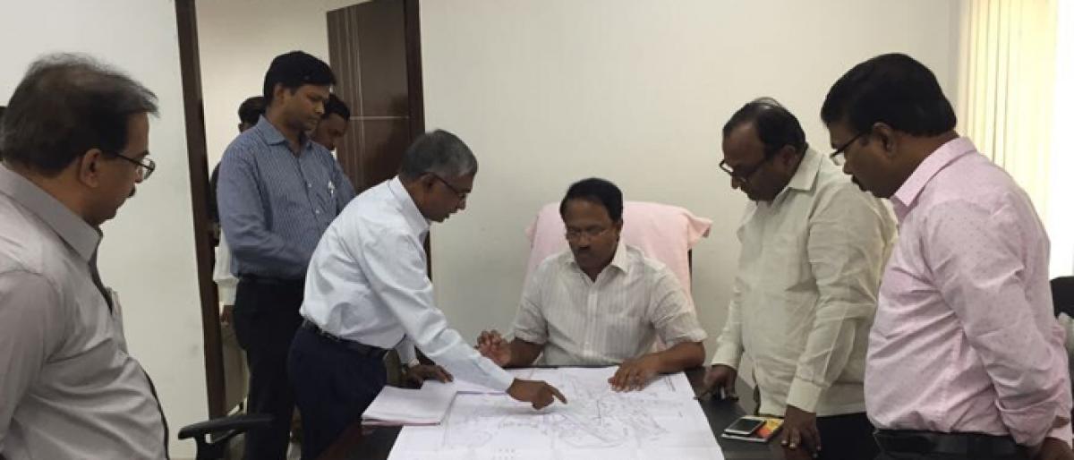 Minister C. Laxma Reddy examines new building designs