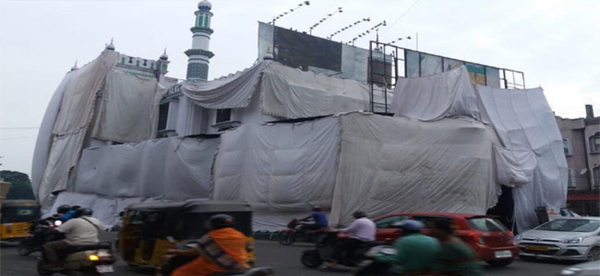 Mosques en route Ganesh procession covered in cloth