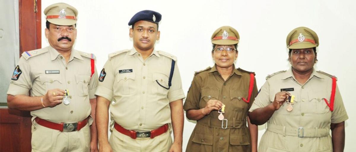 SP Bhusarapu Satya Yesubabu presents police medals to SIs in Ongole