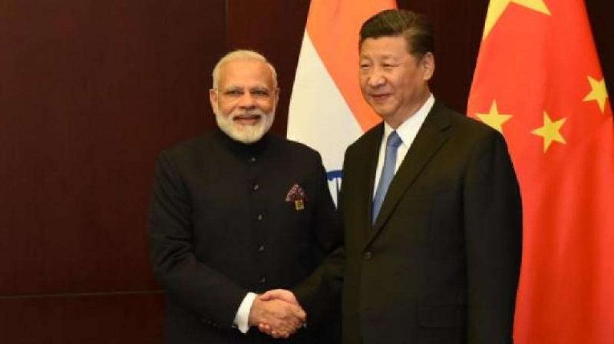 Doklam issue behind us, working with India to enhance ties, says China