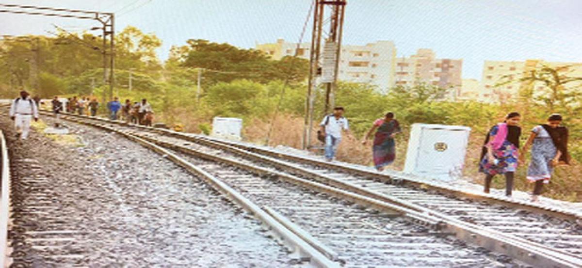 Narrow roads force public to walk through rail track
