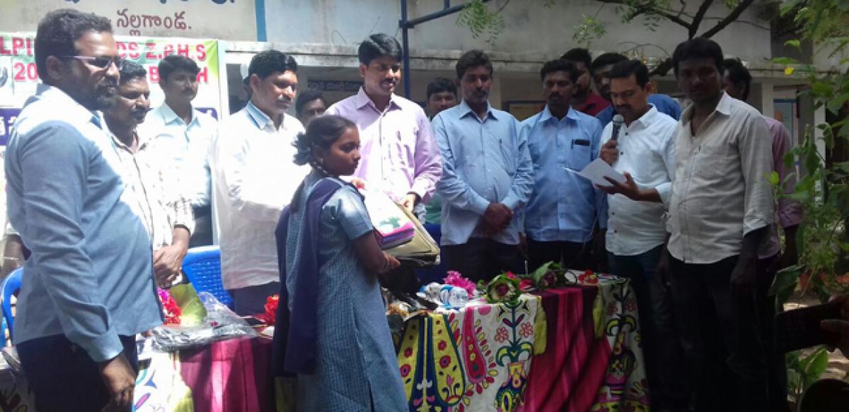 Nalgonda Joint Collector distributes bags, notebooks to students