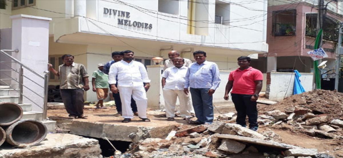 Corporator inspects overflowing drainage