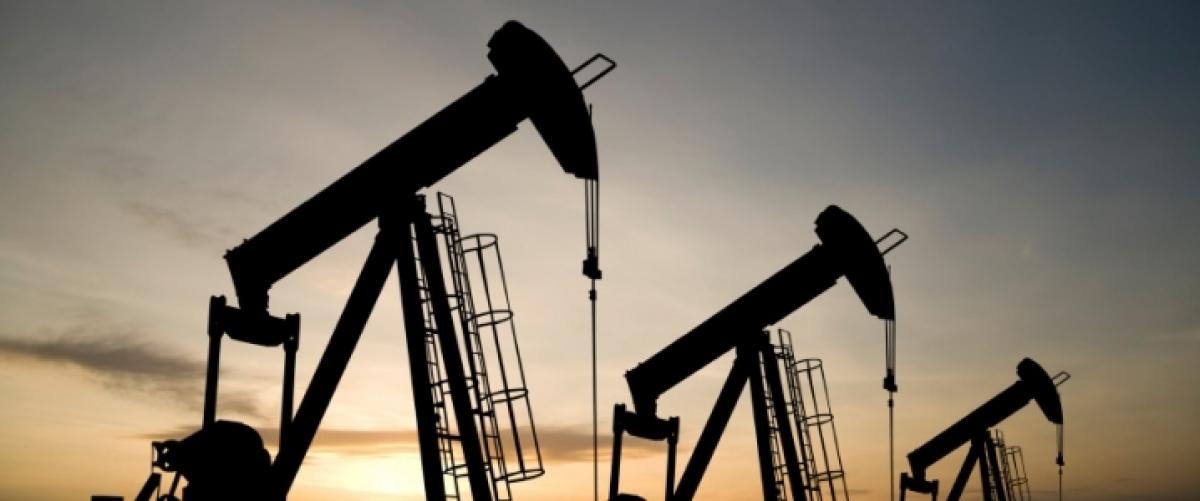 Oil steady on falling crude inventories, but rising output weighs
