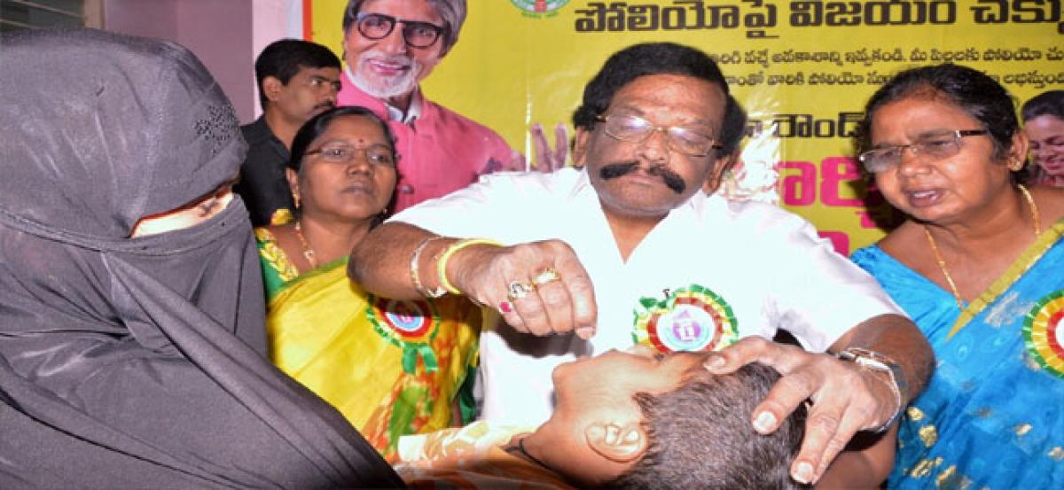 Siddha administers polio drops to children