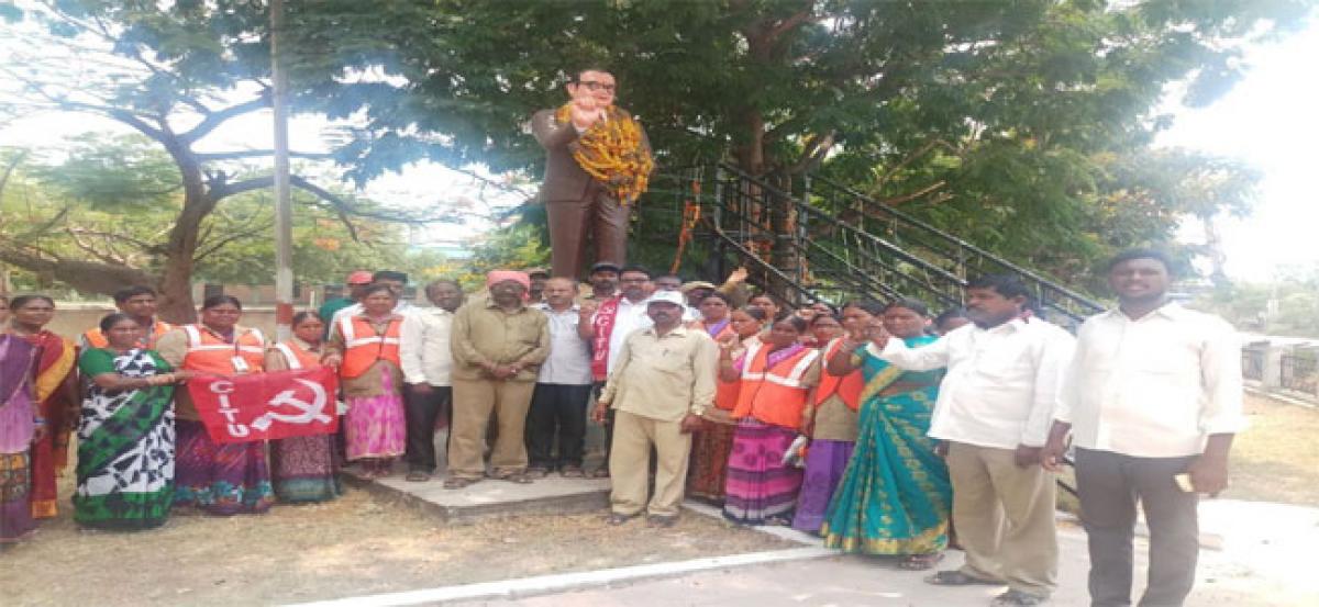 Municipal workers stage protest at Ambedkar statue