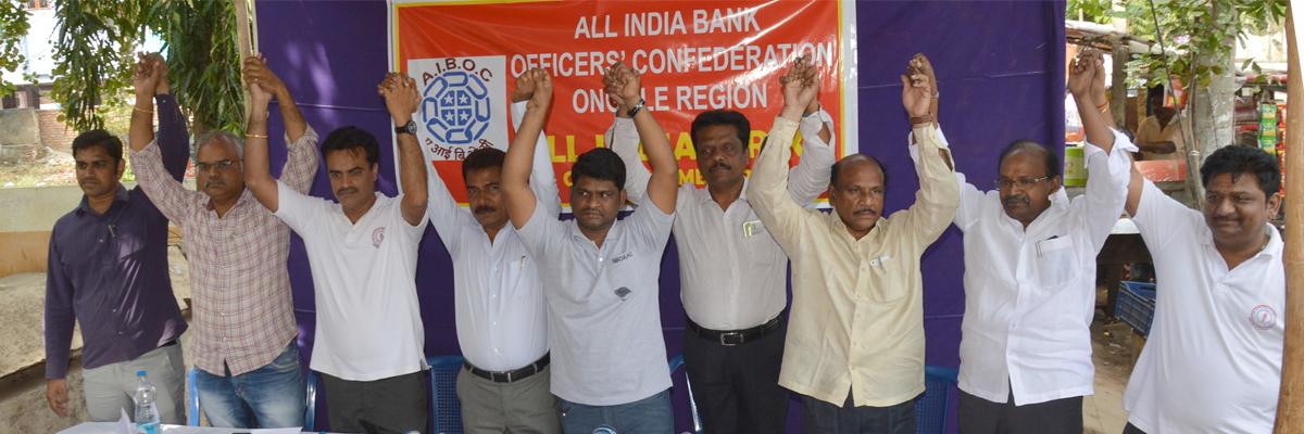 Bankers protest merger, merit based pay scale