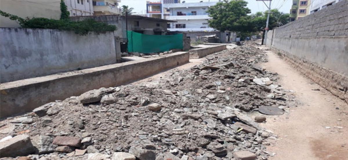 GHMC cleans Nala; leaves silt on road