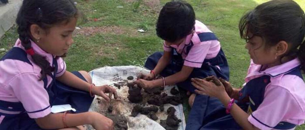 Garepalli ZP students distribute clay Ganeshas