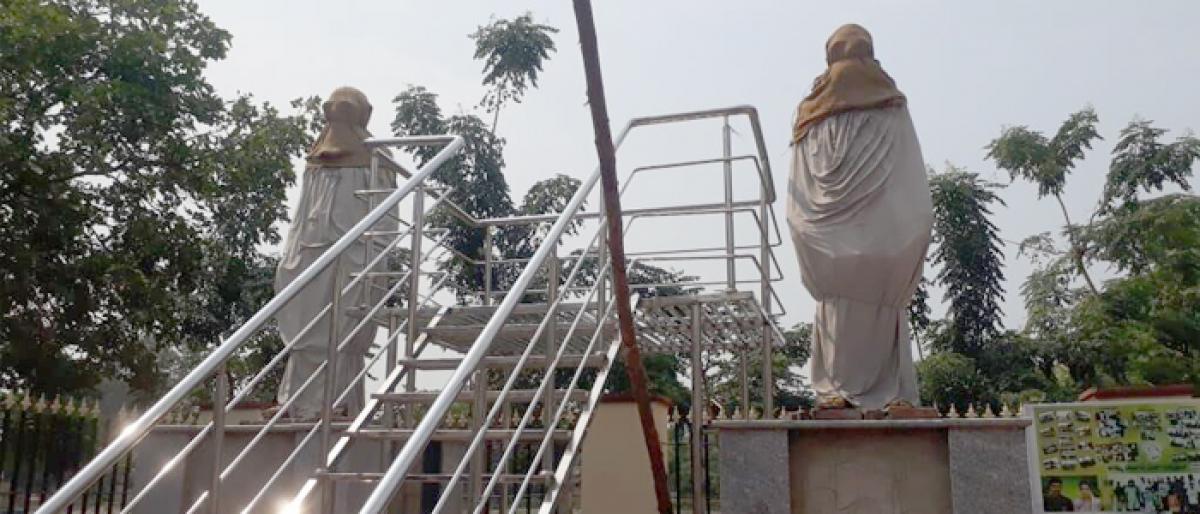 Two prominent persons statues remain covered