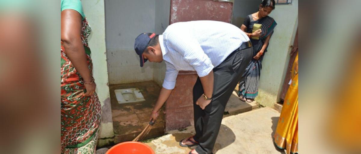 ITDA project officer Nishant Kumar cleans hostel toilets at Kothada Tribal Welfare Hostel in Gangavaram Mandal