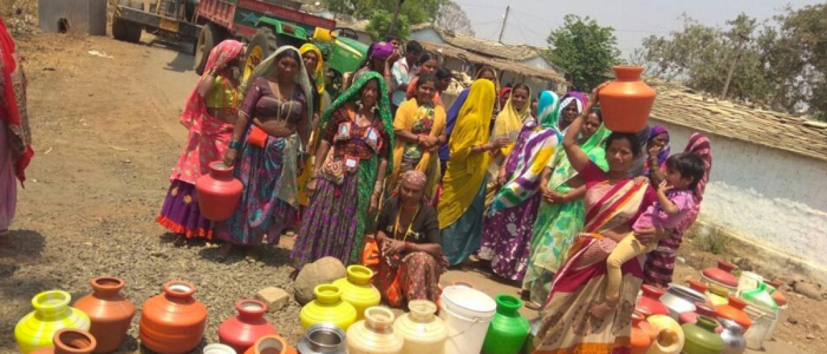 Tribal stage dharna displaying empty pitchers in Vikarabad district