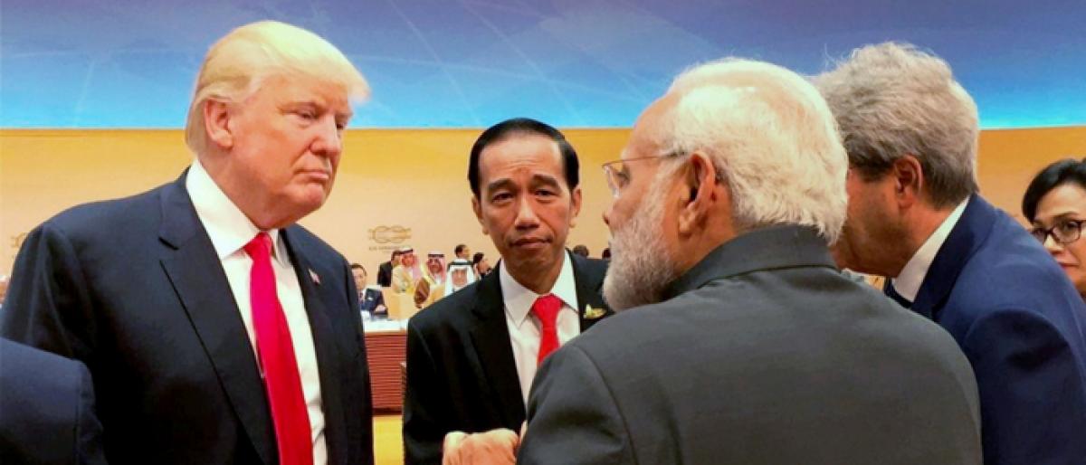 Trump waves to Modi,walks to him for chat