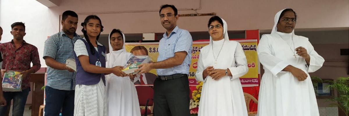 Tulasi group MD distributes books in Vijayawada