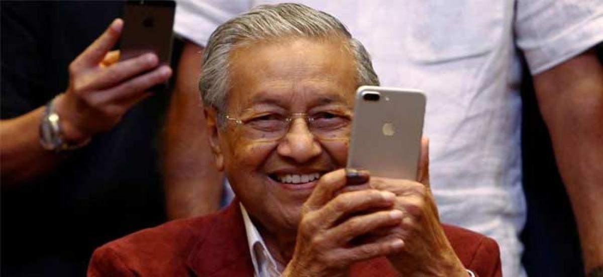 Veteran 92-year-old leader and ex-PM Mahathir Mohamad leads Opposition coalition to victory in Malaysian election