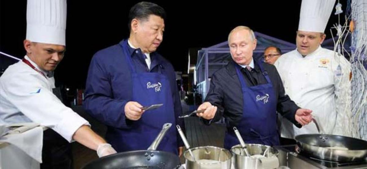 Vladimir Putin, Xi Jinping flip pancakes at Russian economic forum